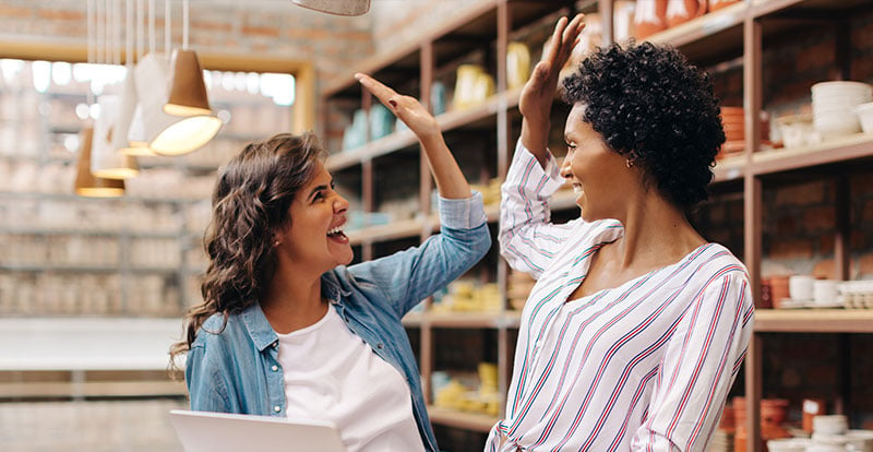 2 business owners high-fiving