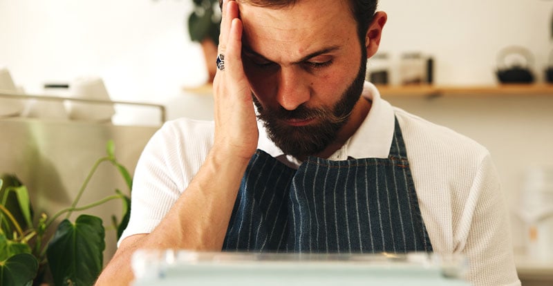 Photo of man with hand on head seeming confused and sad